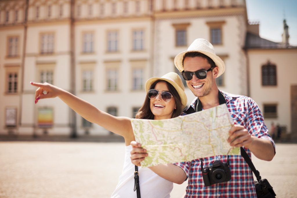 A couple traveling using a map.