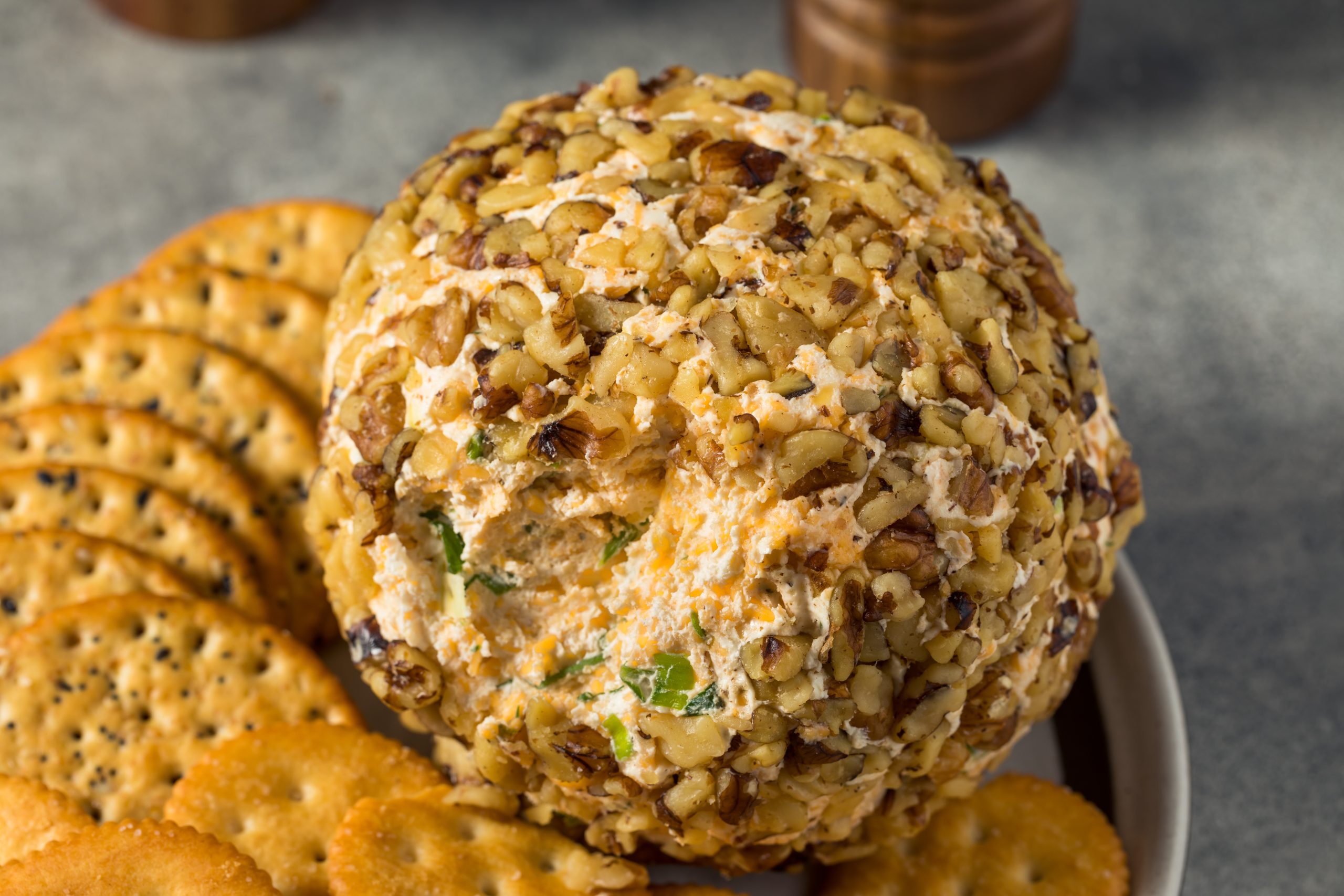 Nut covered cheeseball and crackers.