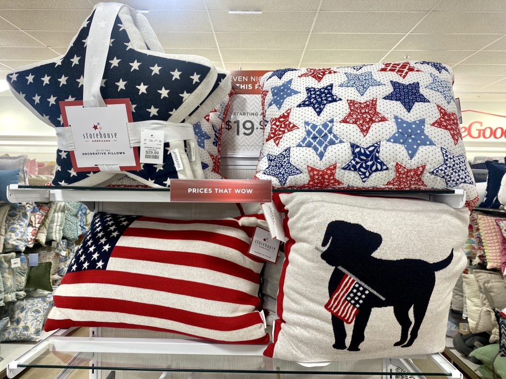 a display of patriotic pillows on a shelf
