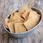 almond flour crackers in a metal container.